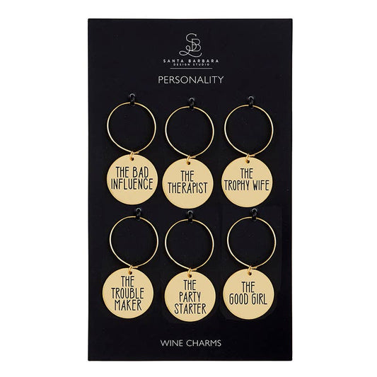 Set of six gold wine charms with humorous phrases on a black card, branded 'Santa Barbara Design Studio'.
