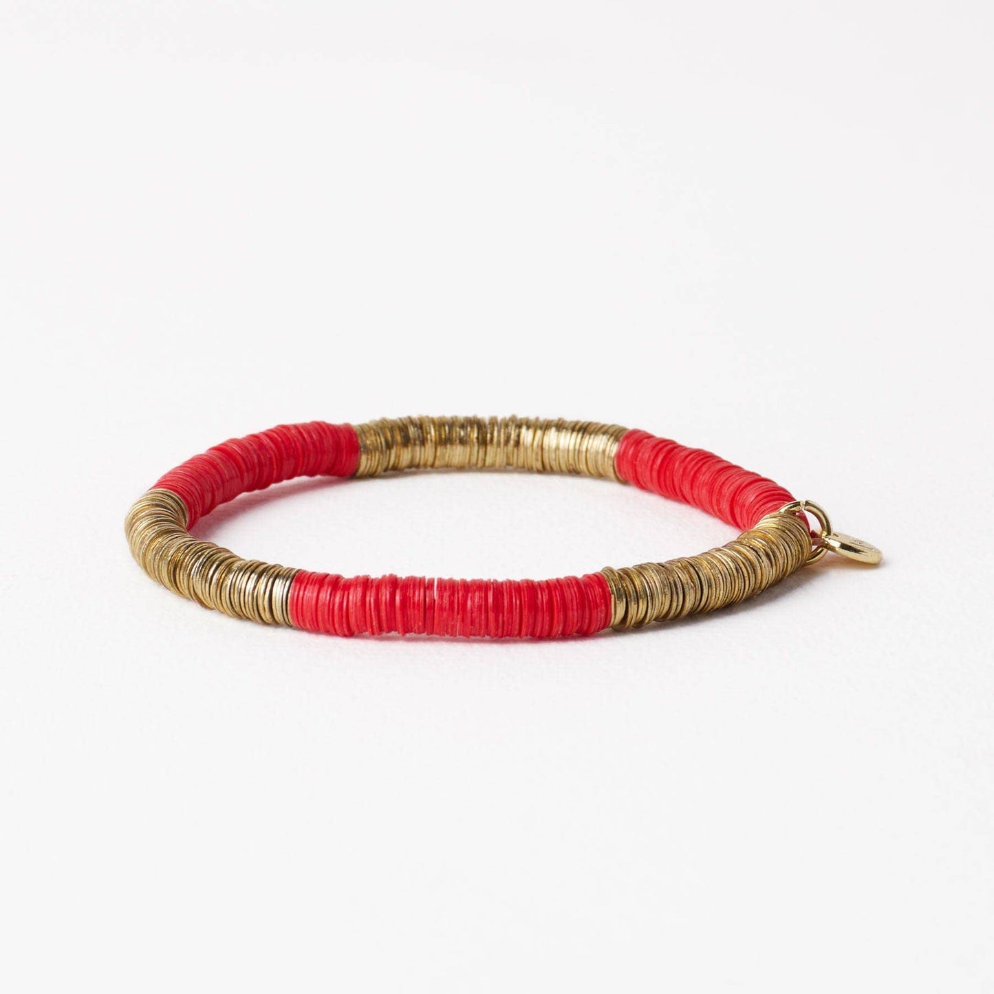 Bracelet with red and gold bands on a white background