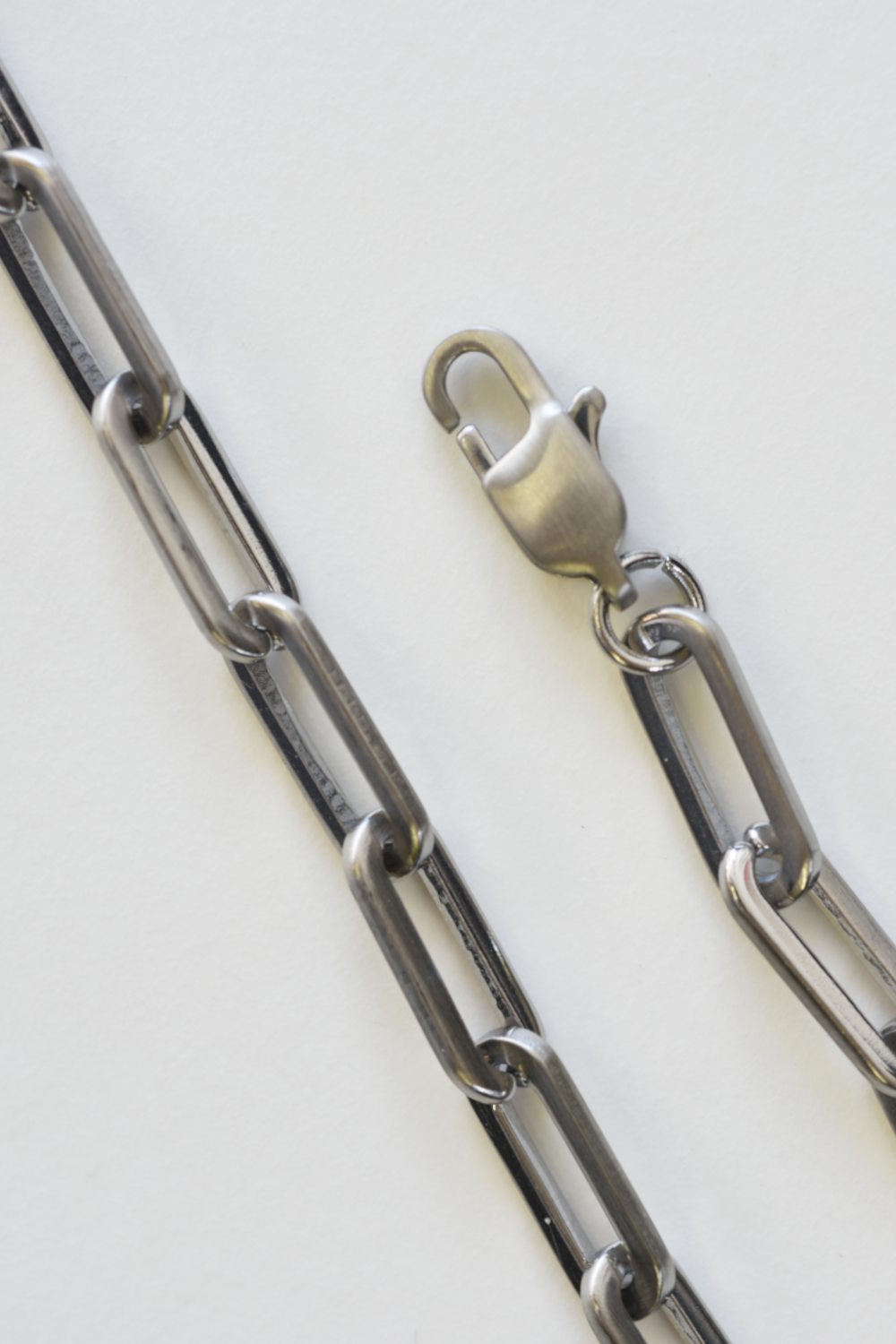 Metallic chain with a clasp on a white background