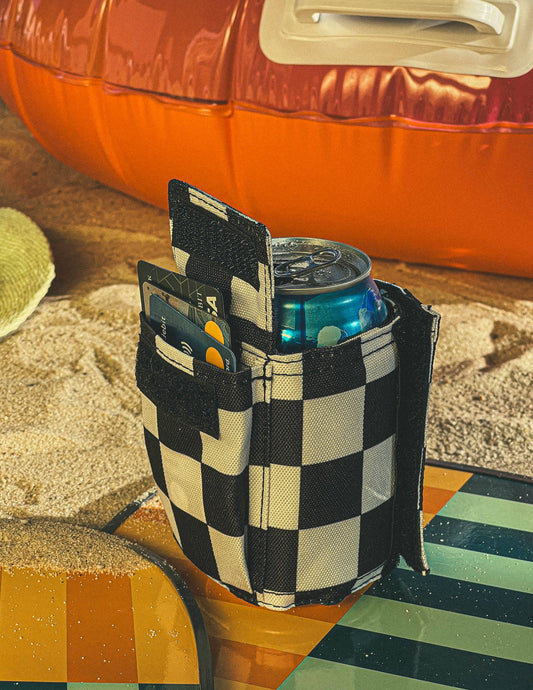 Checkered cooler pouch with a can of soda on a colorful surface