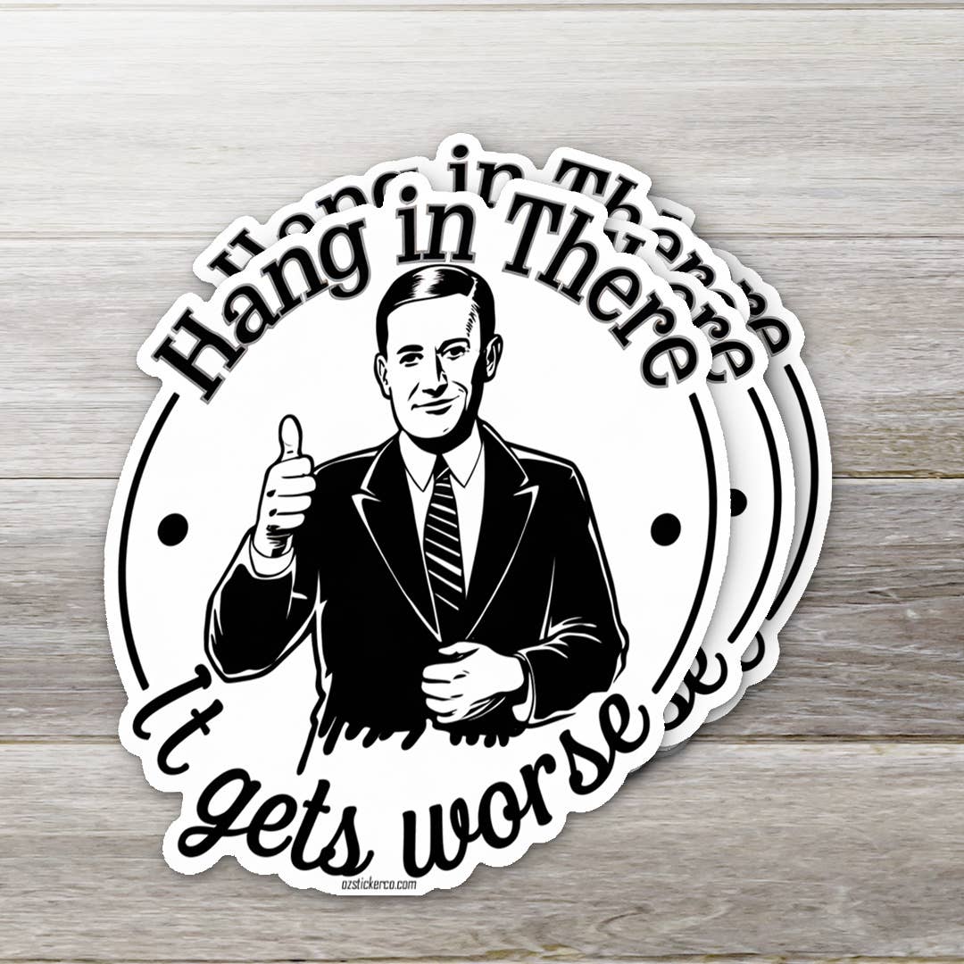 Circular sticker with a man giving a thumbs up and text 'Hang in there, it gets worse' on a wooden background