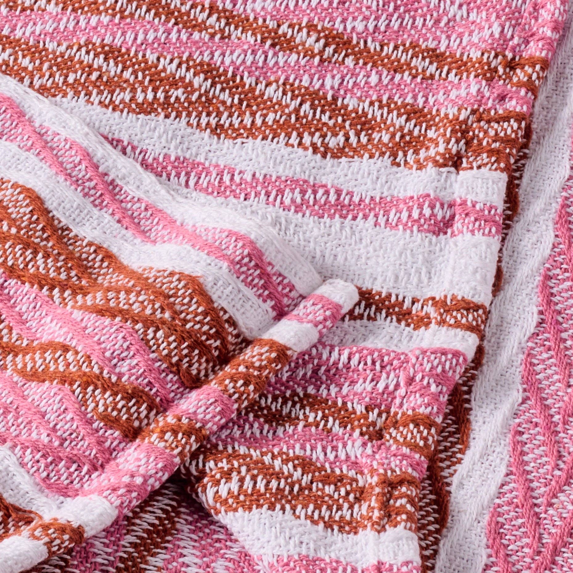 Close-up of a pink, brown, and white striped fabric texture.