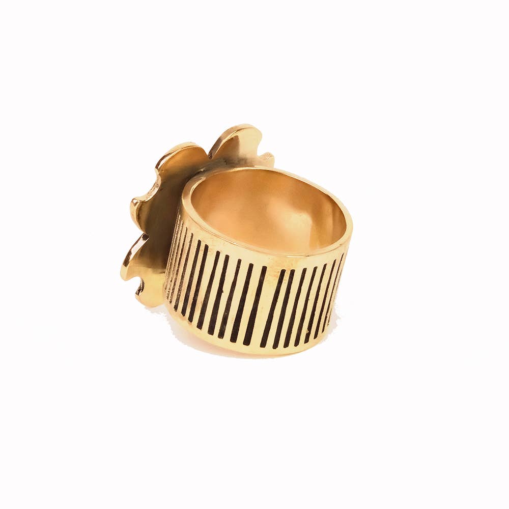 Gold ring with a textured design on a white background