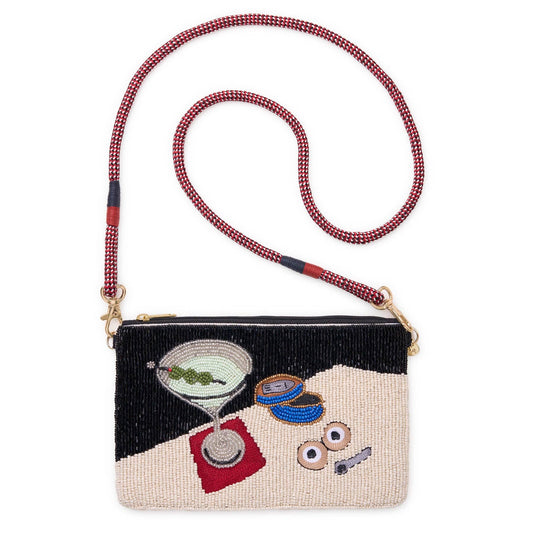A beaded shoulder bag with a geometric black and beige design, featuring embroidered cocktail and food motifs, a red-and-white beaded strap, and gold-tone hardware, shown on a plain white background.