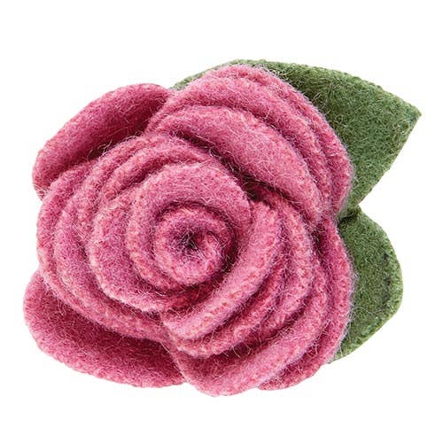 Pink felt rose with a green leaf on a white background
