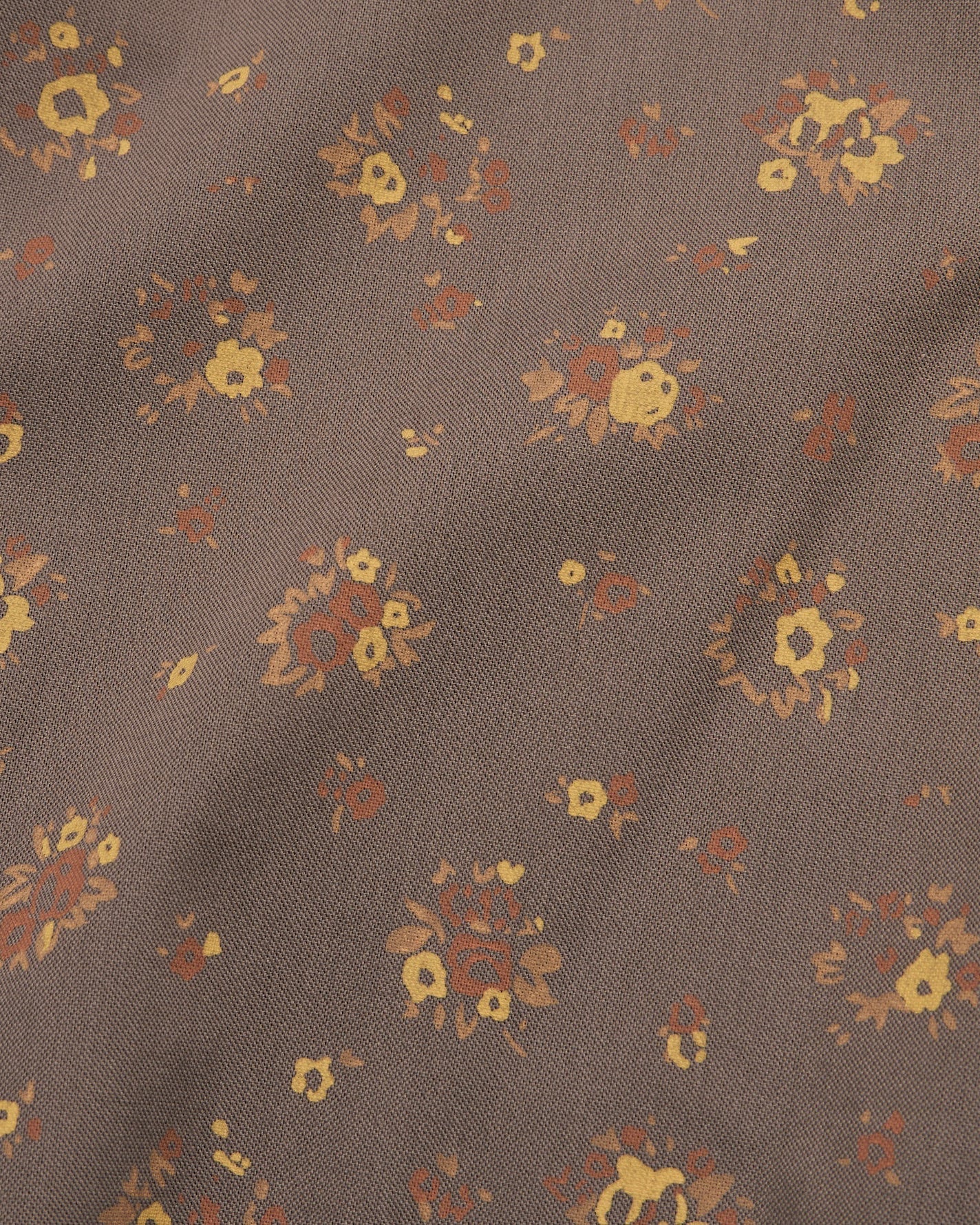 Floral pattern on a brown fabric background