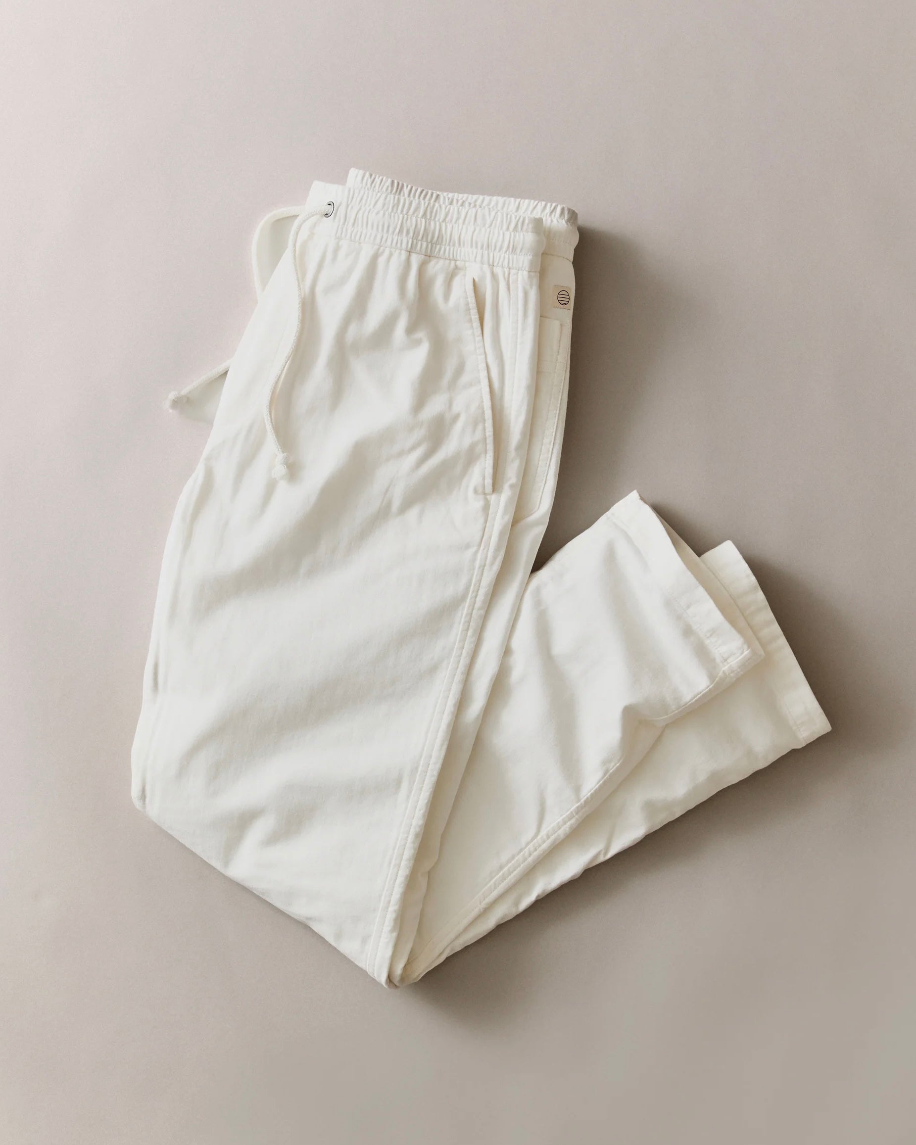 White pants on a beige background