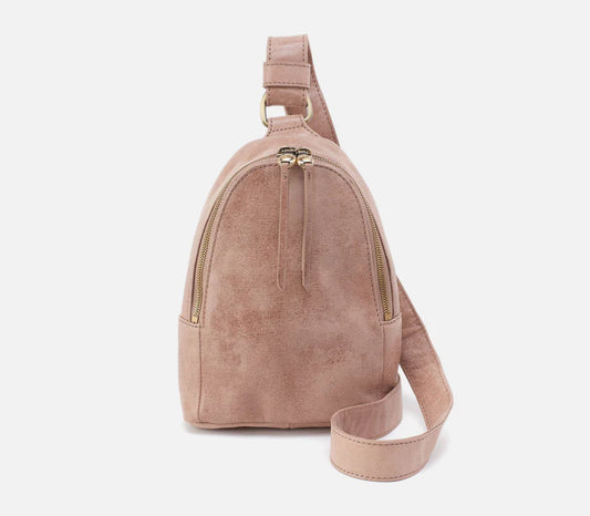 Pink suede backpack with a strap on a white background