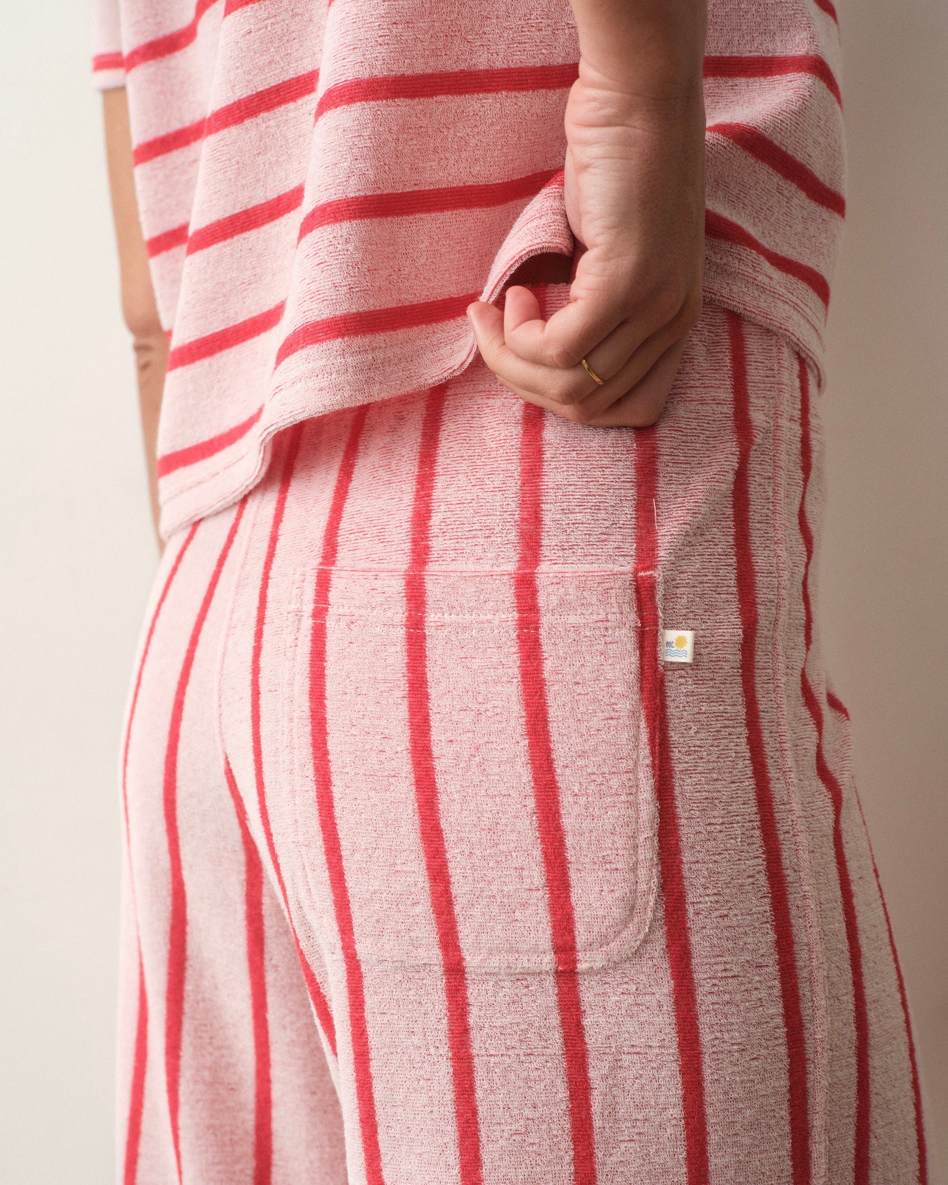 Red and white striped outfit with a visible brand logo on a neutral background