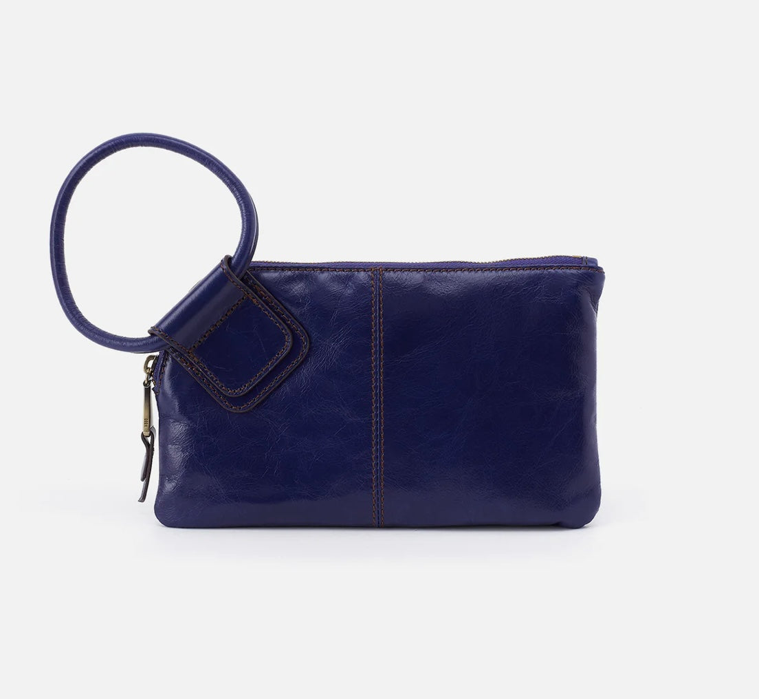 Navy blue leather clutch bag with a matching keychain on a white background