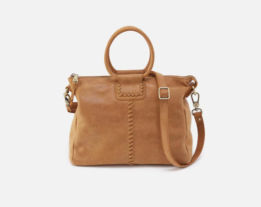 Brown leather handbag with a strap on a white background