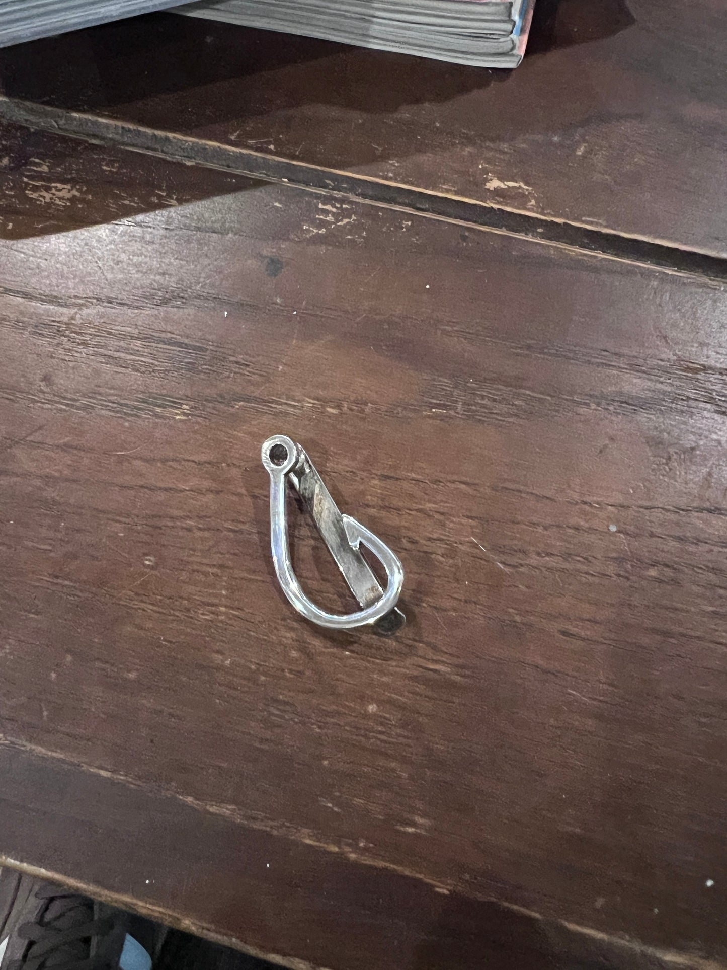 Metal carabiner attached to a wooden surface