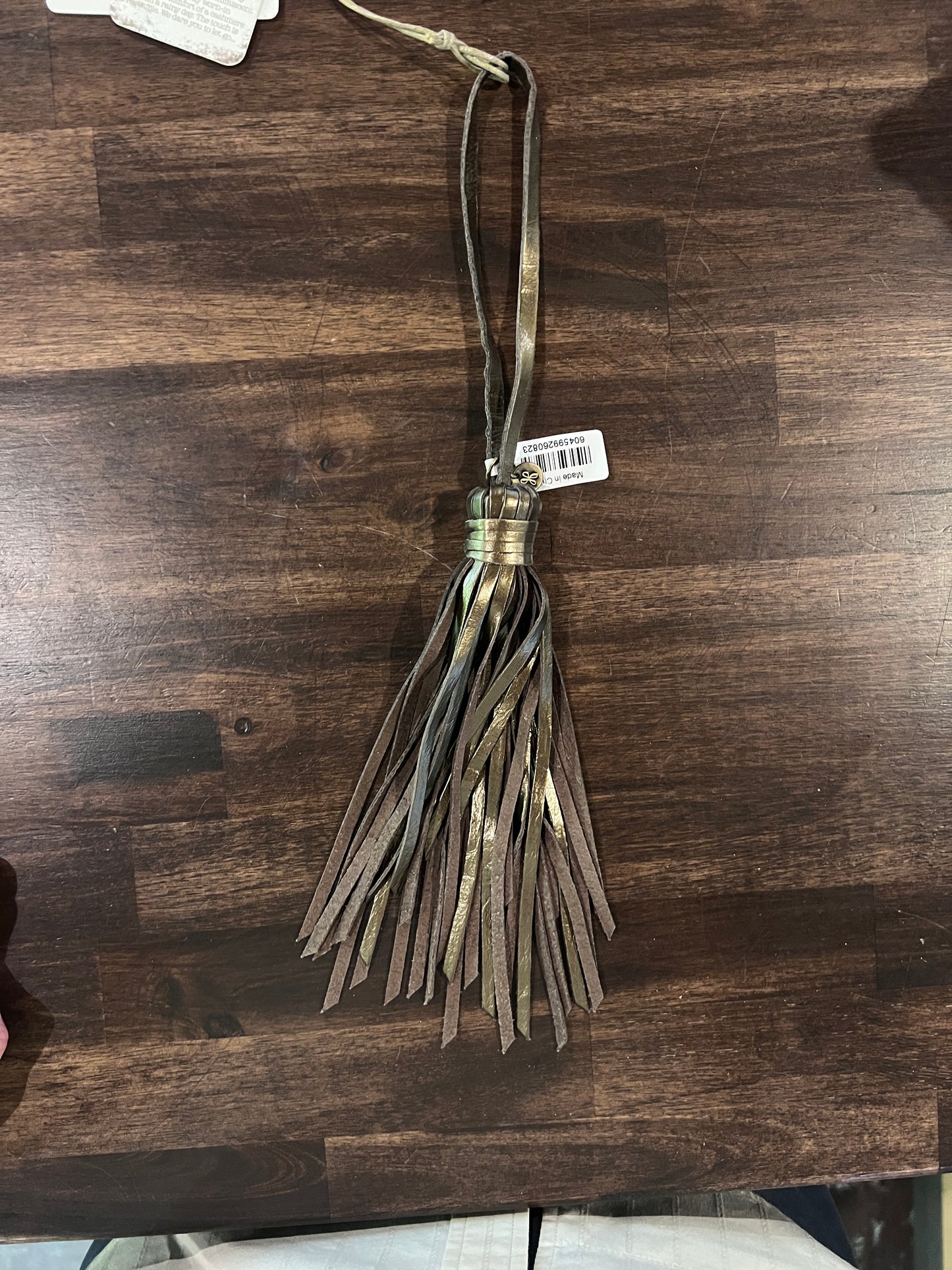 Tassel with a tag on a wooden surface