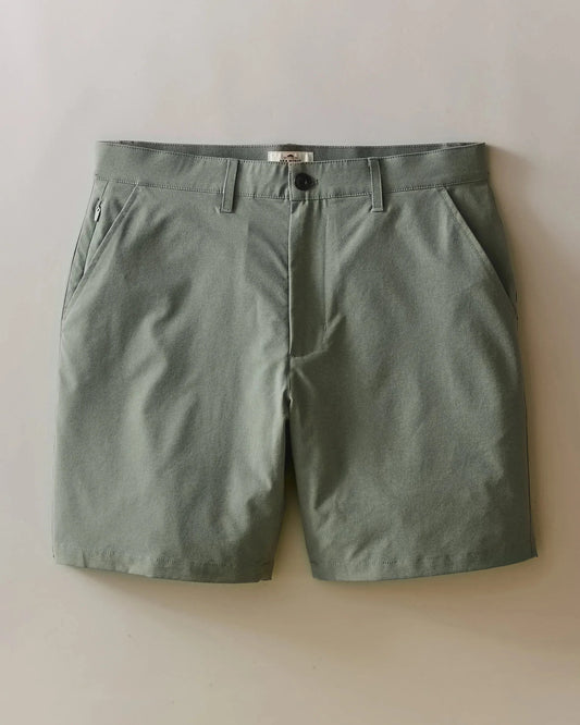 Green shorts on a light beige background