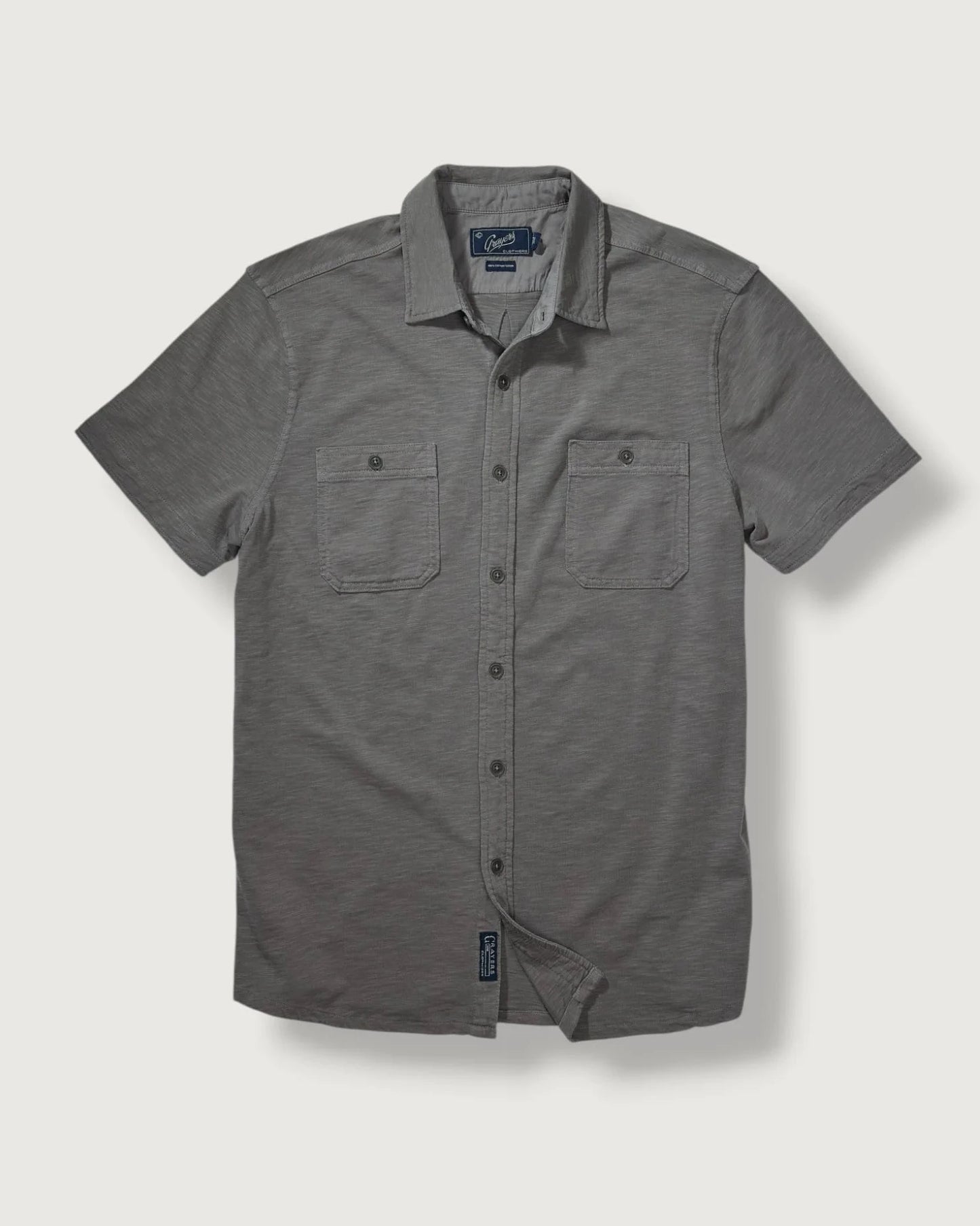 Gray short-sleeve button-up shirt on a light gray background