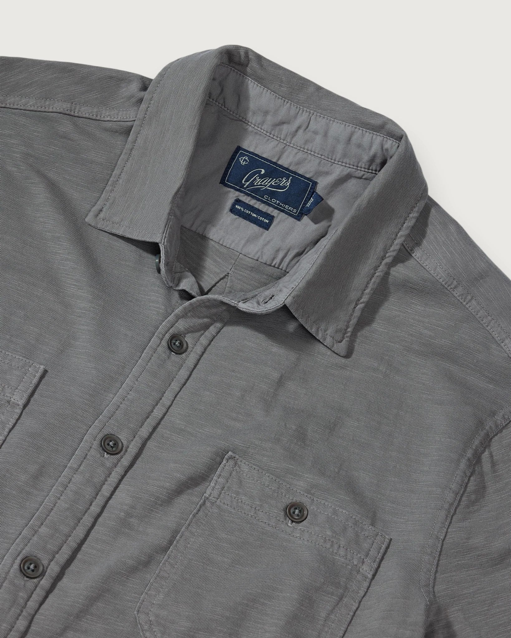 Gray button down shirt against white background