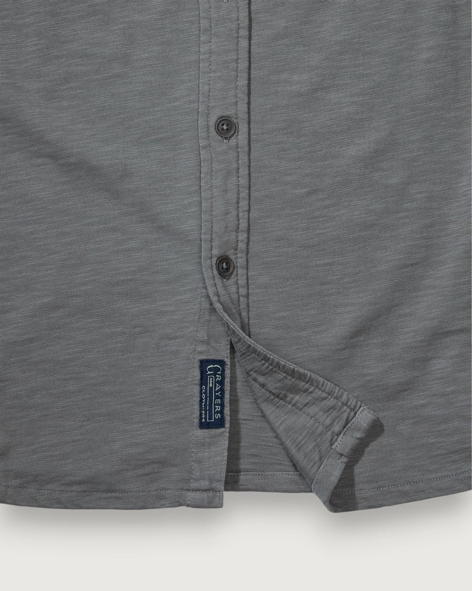 Gray shirt with a brand label on a white background