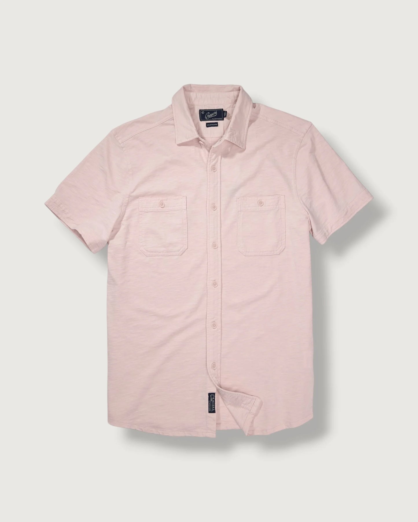 Pink short-sleeve shirt on a light gray background