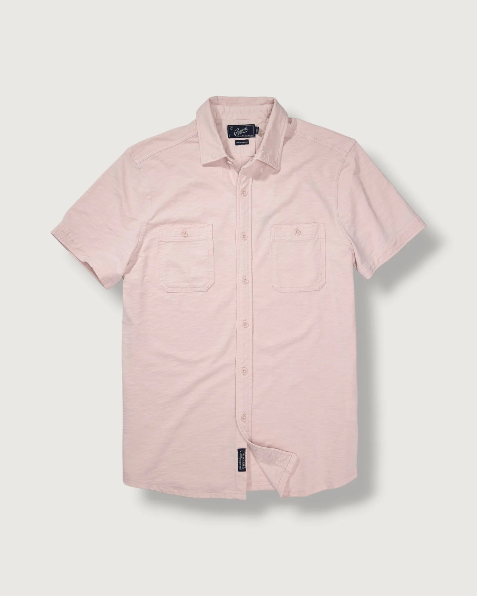 Pink short-sleeve shirt on a light gray background