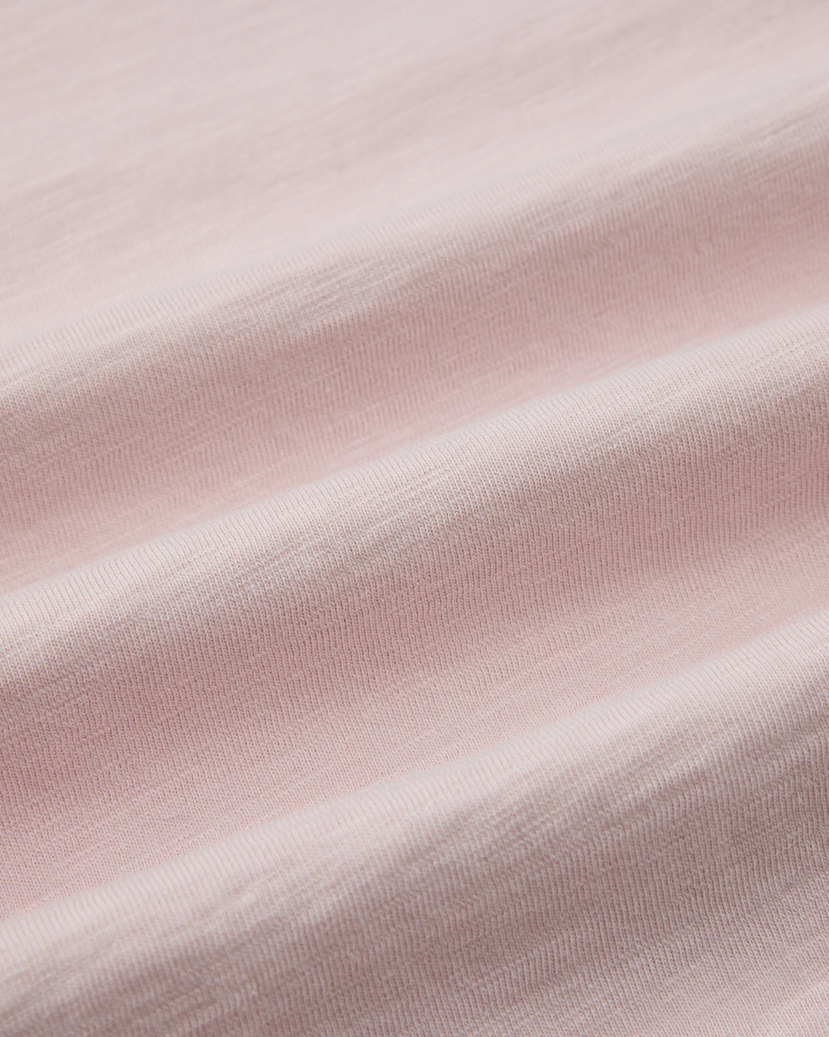 Close-up of light pink fabric texture