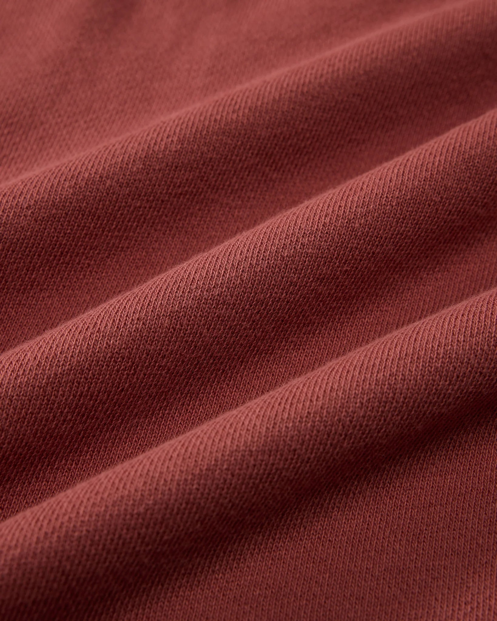 Close-up of maroon fabric with visible texture