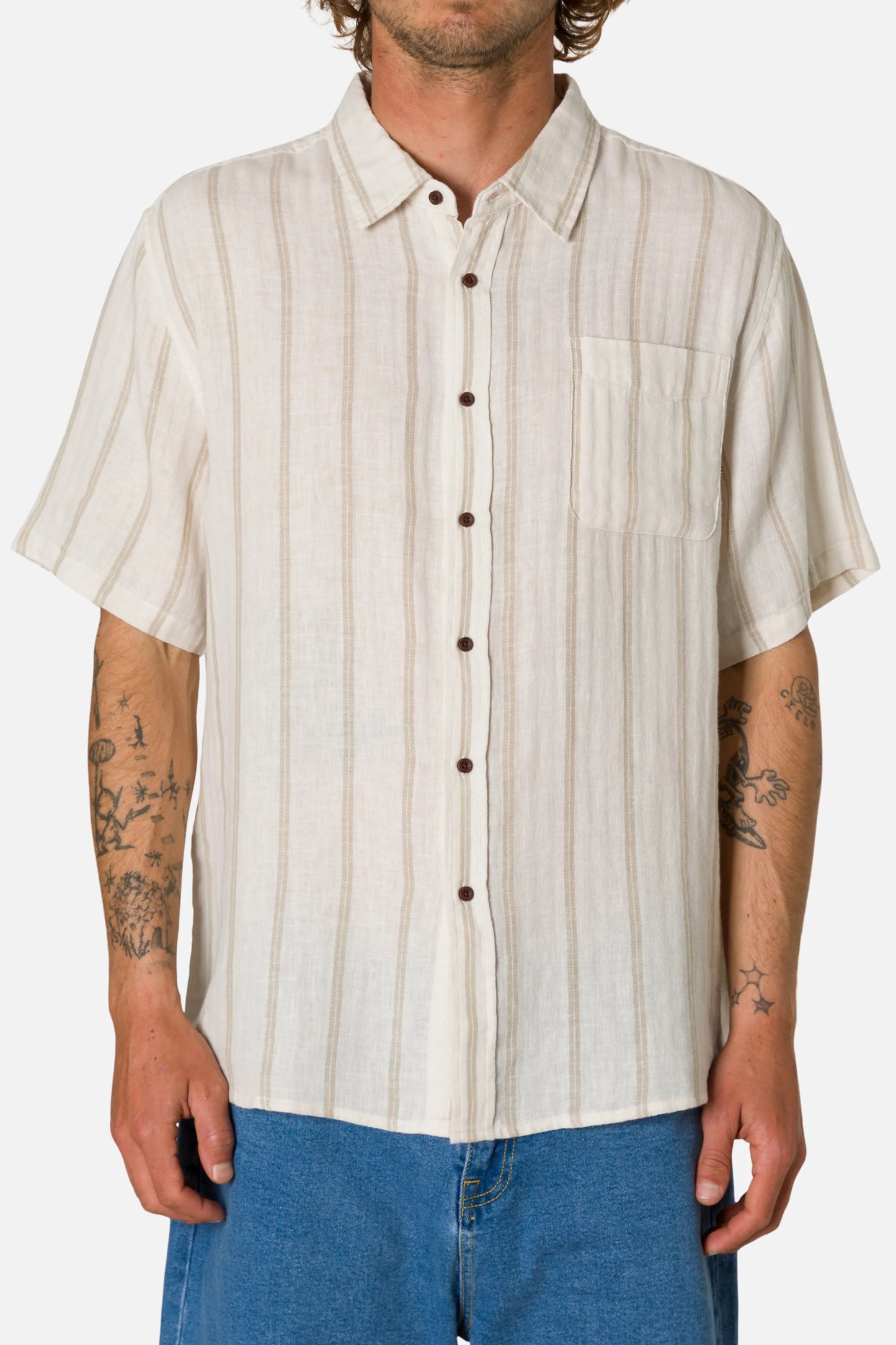 Man wearing a beige striped shirt with short sleeves on a white background