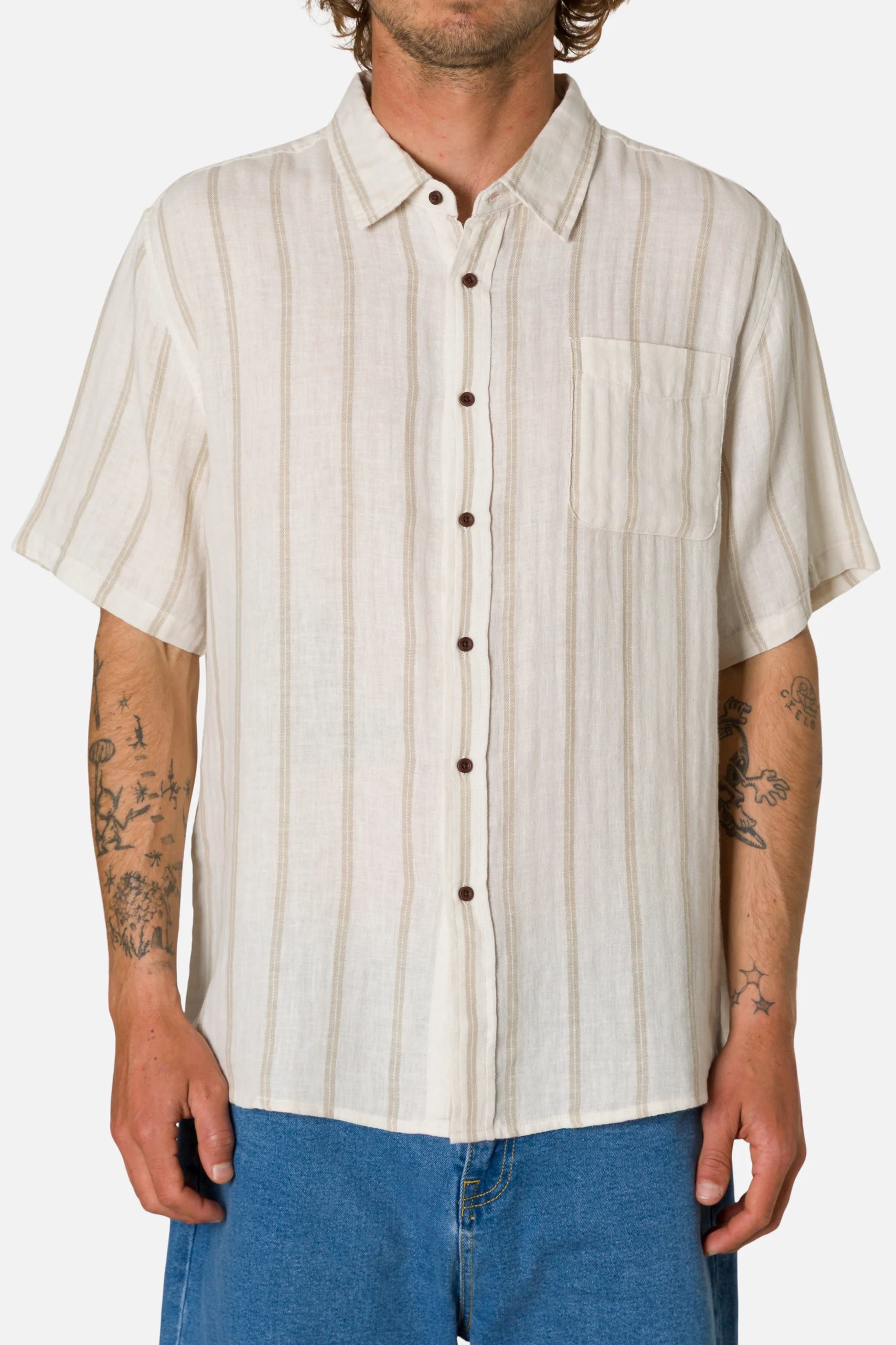 Man wearing a beige striped shirt with short sleeves on a white background
