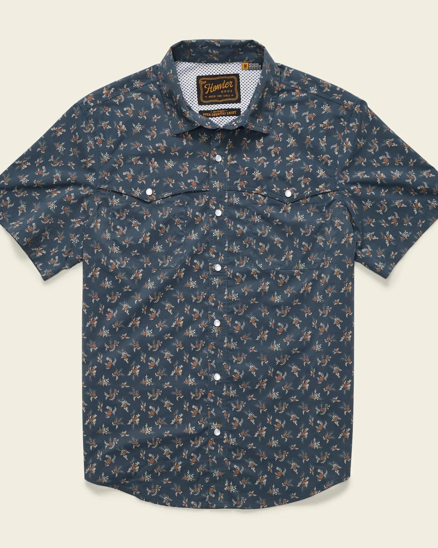 Blue floral patterned shirt on a beige background