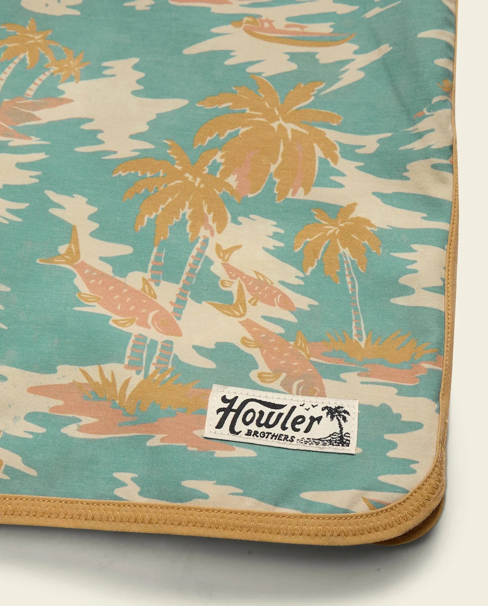 Palm tree patterned fabric with Howler Brothers label on a white background