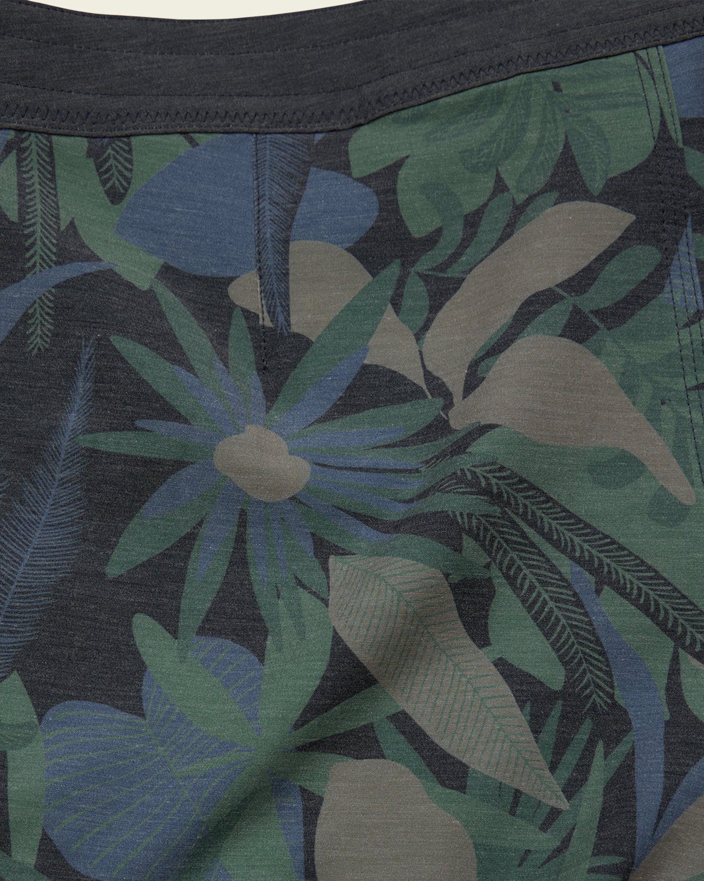 Close-up of a tropical leaf patterned fabric with dark background