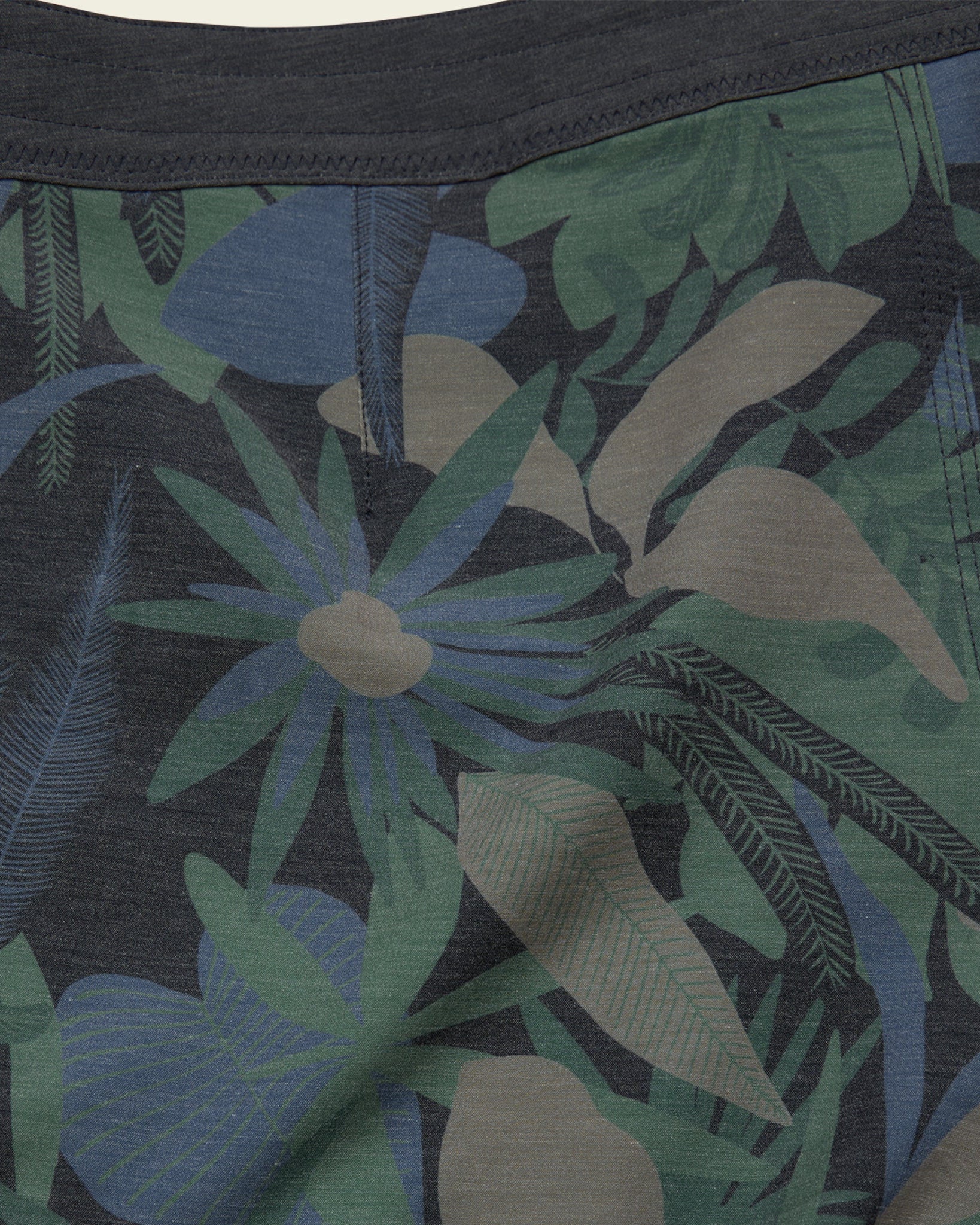 Close-up of a tropical leaf patterned fabric with dark background