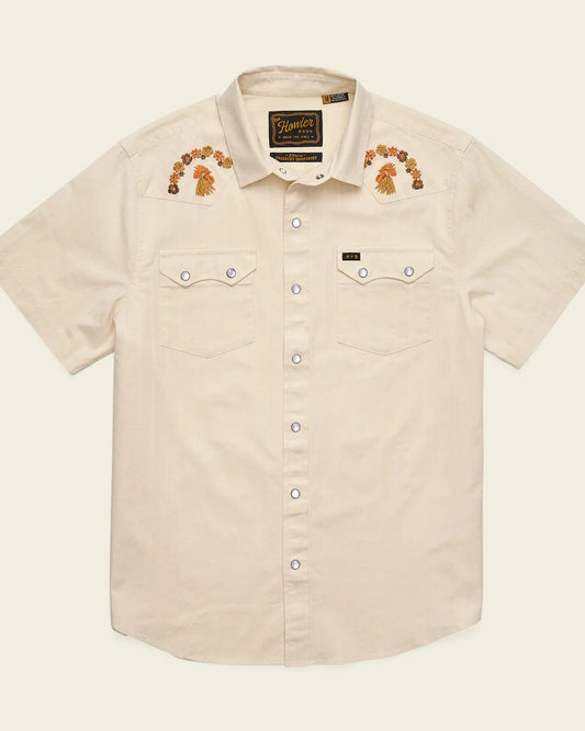 Beige short-sleeve shirt with embroidered designs on a beige background