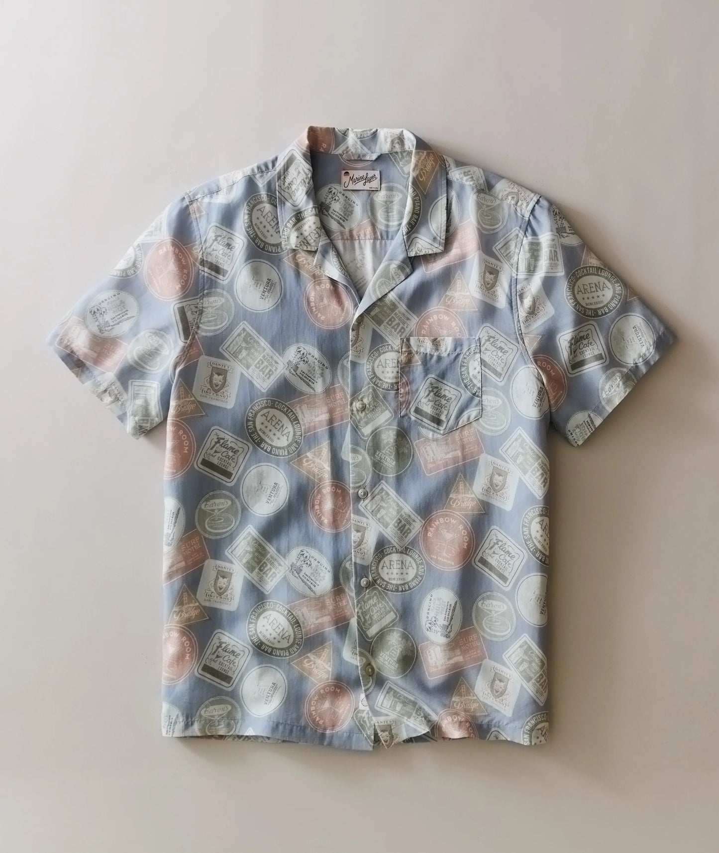 Short-sleeve shirt with bottle pattern on a beige background