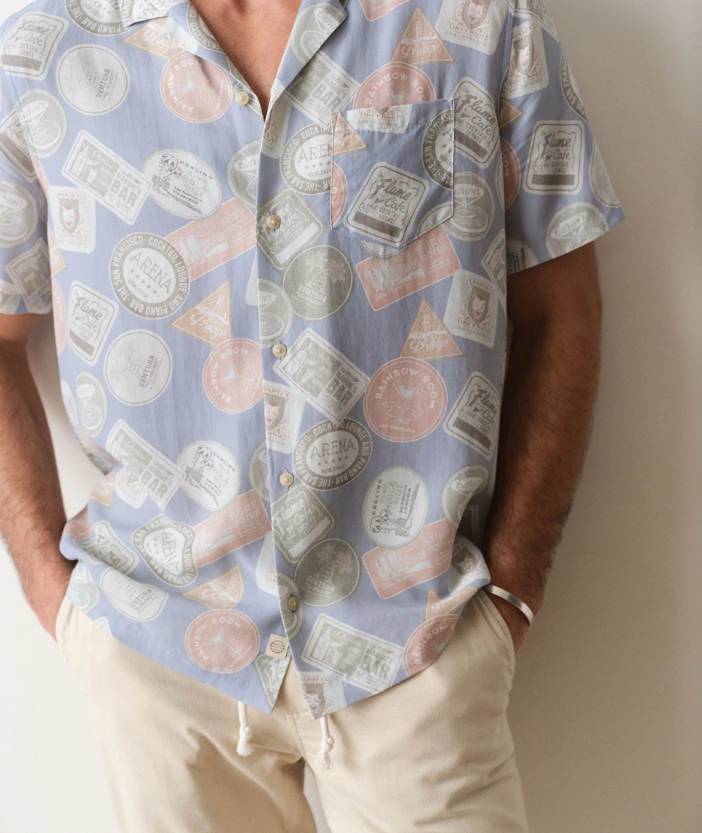 Person wearing a patterned shirt with a neutral background