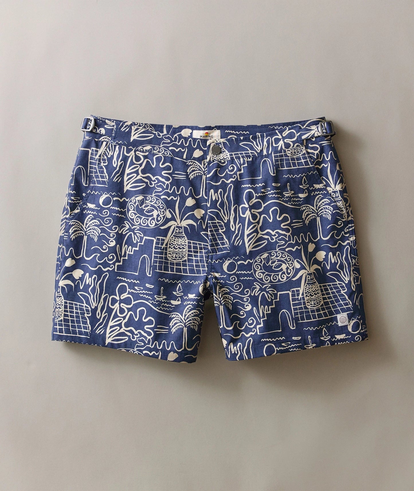 Blue shorts with white patterns on a plain background
