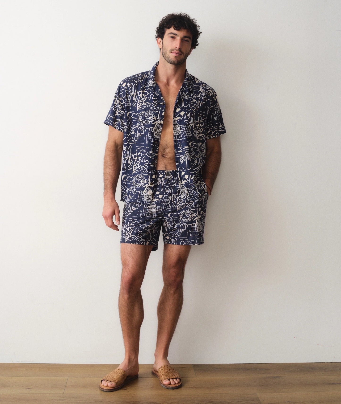 Man wearing a matching shirt and shorts set with a white background