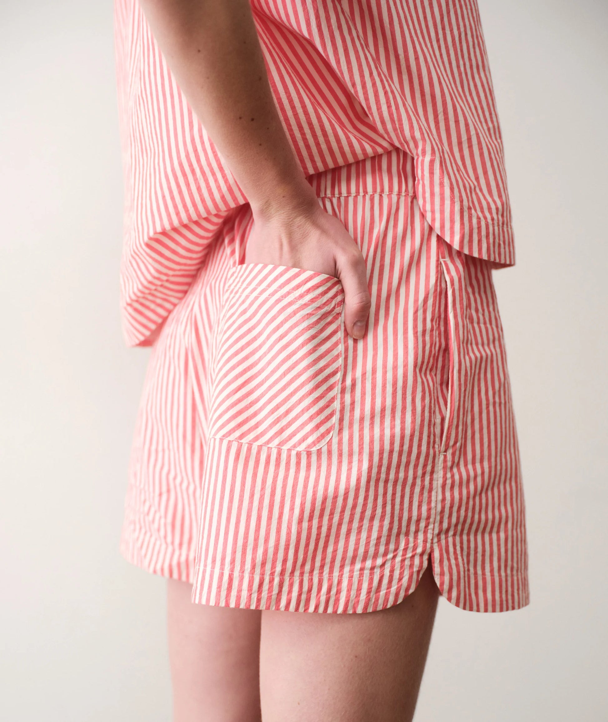 Red and white striped outfit with a plain background