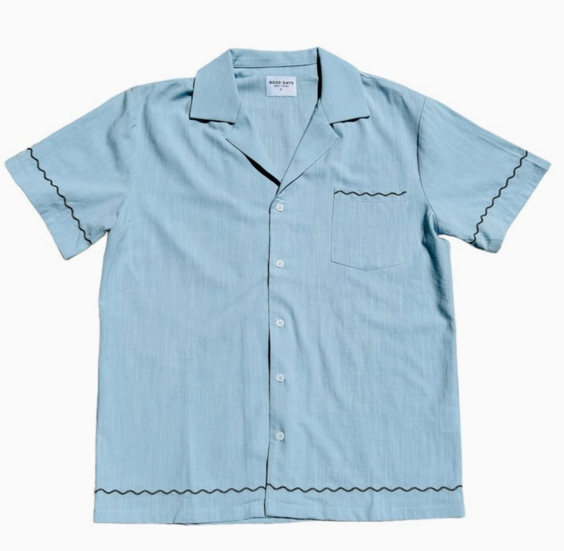 Light blue shirt with scalloped trim detail. Camp collar.  Lightweight fabric. 