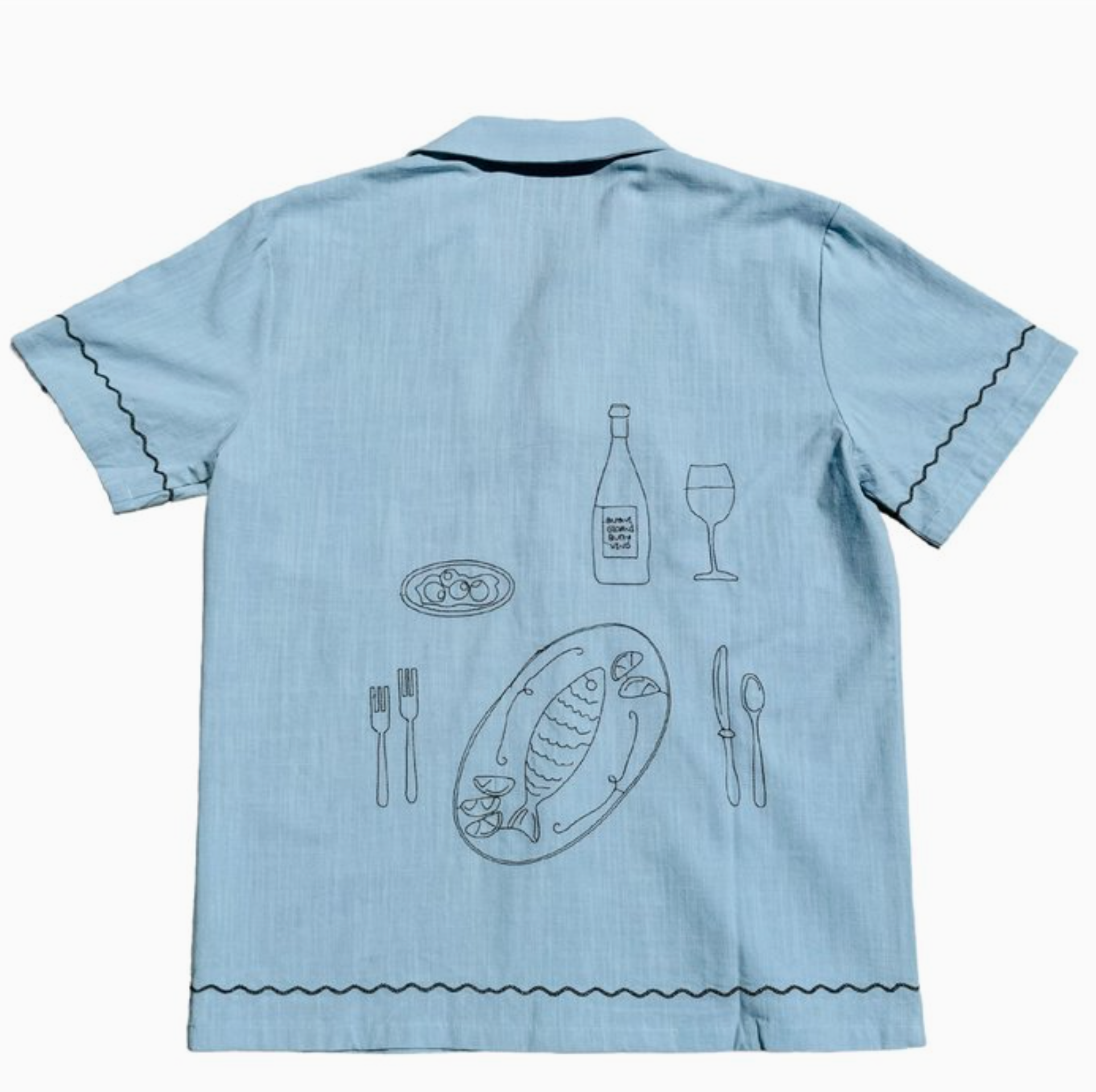 Back of a light blue woven shirt with an embroidered dinner scene 