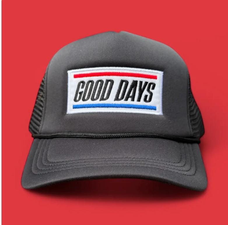 Black trucker hat with GOOD DAYS written across cap, red background