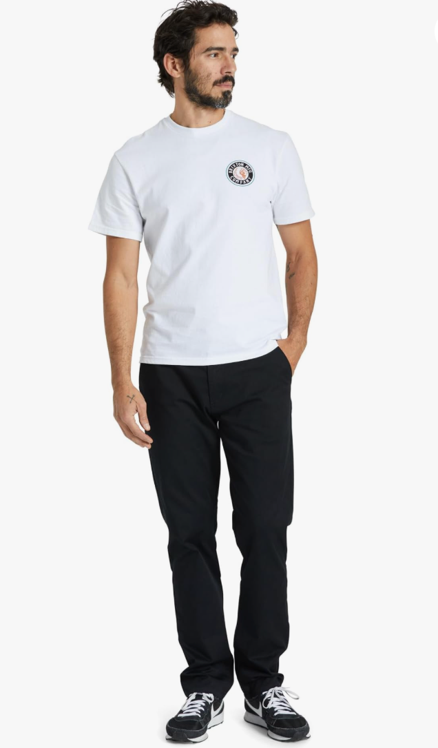 Man wearing a white t-shirt with a logo and black pants on a white background