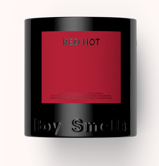 Candle with 'Red Hot' label and 'Boy Smells' branding on a white background