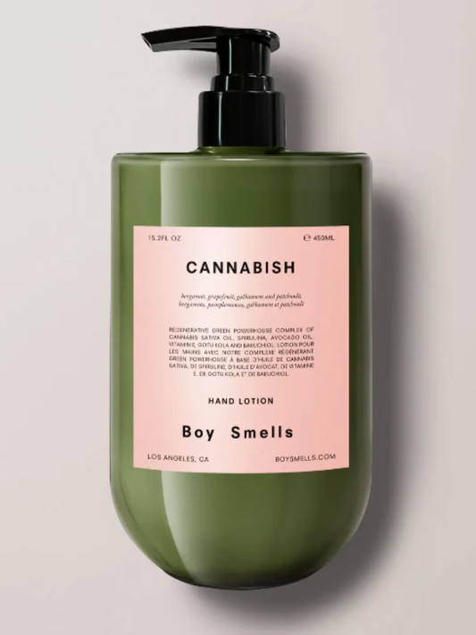 Green hand lotion bottle with pink label on a light gray background