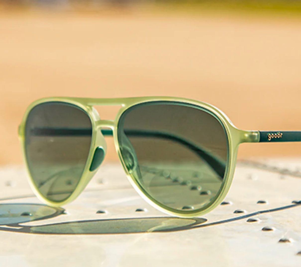 Green sunglasses with a blurred background