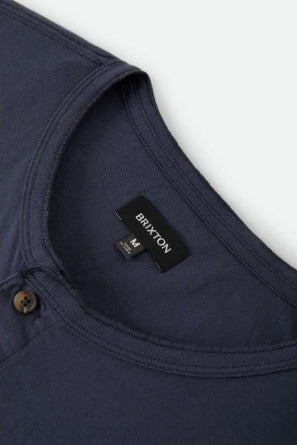 Navy shirt with a Brixton label on a white background