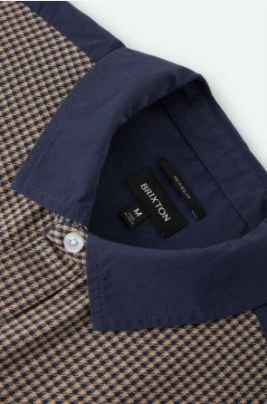 Close-up of a navy shirt with a patterned collar and Brixton label.