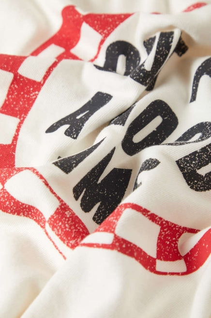 Close-up of a fabric with red and black patterns on a white background