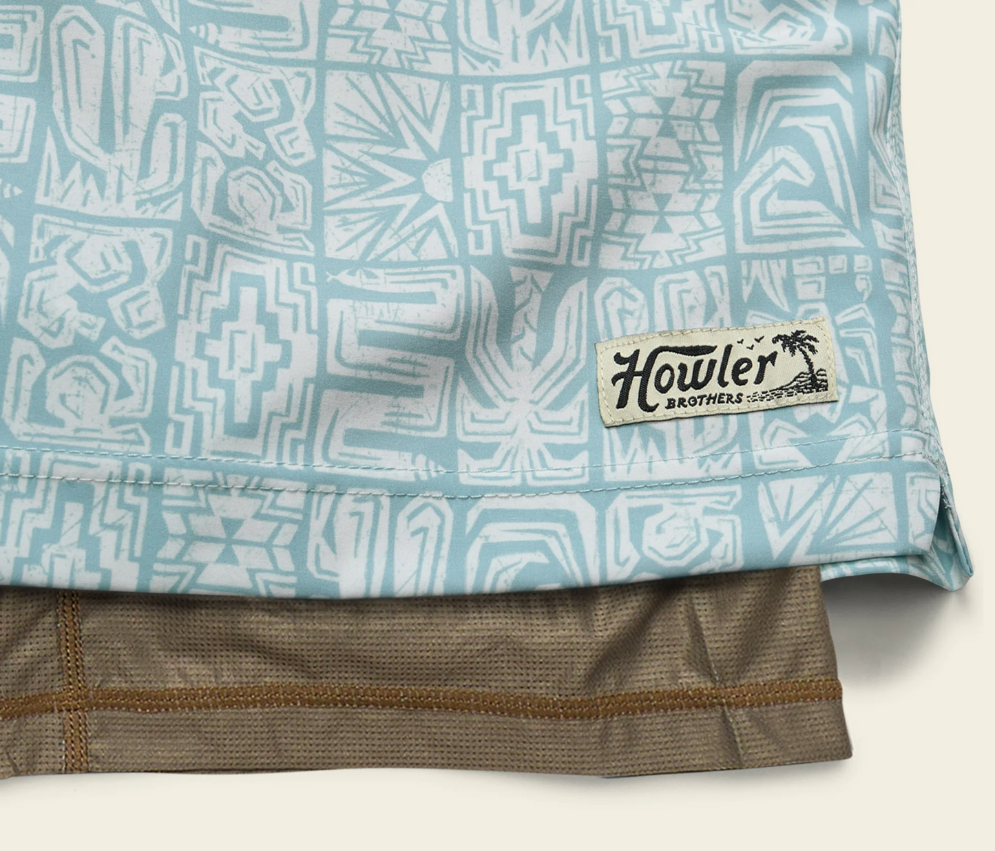 Close-up of a patterned shirt with a Howler Brothers label on a light background