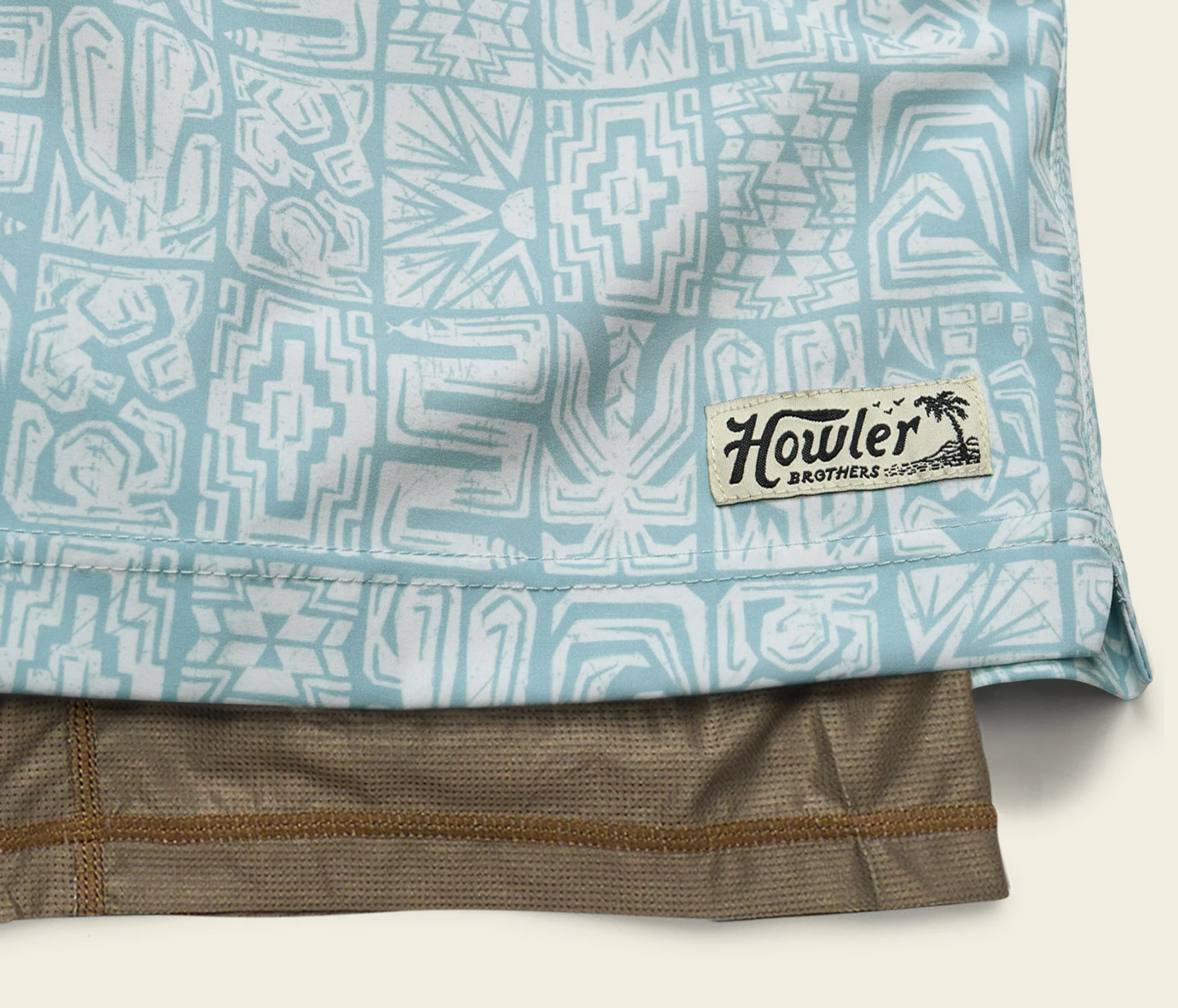 Close-up of a patterned shirt with a Howler Brothers label on a light background