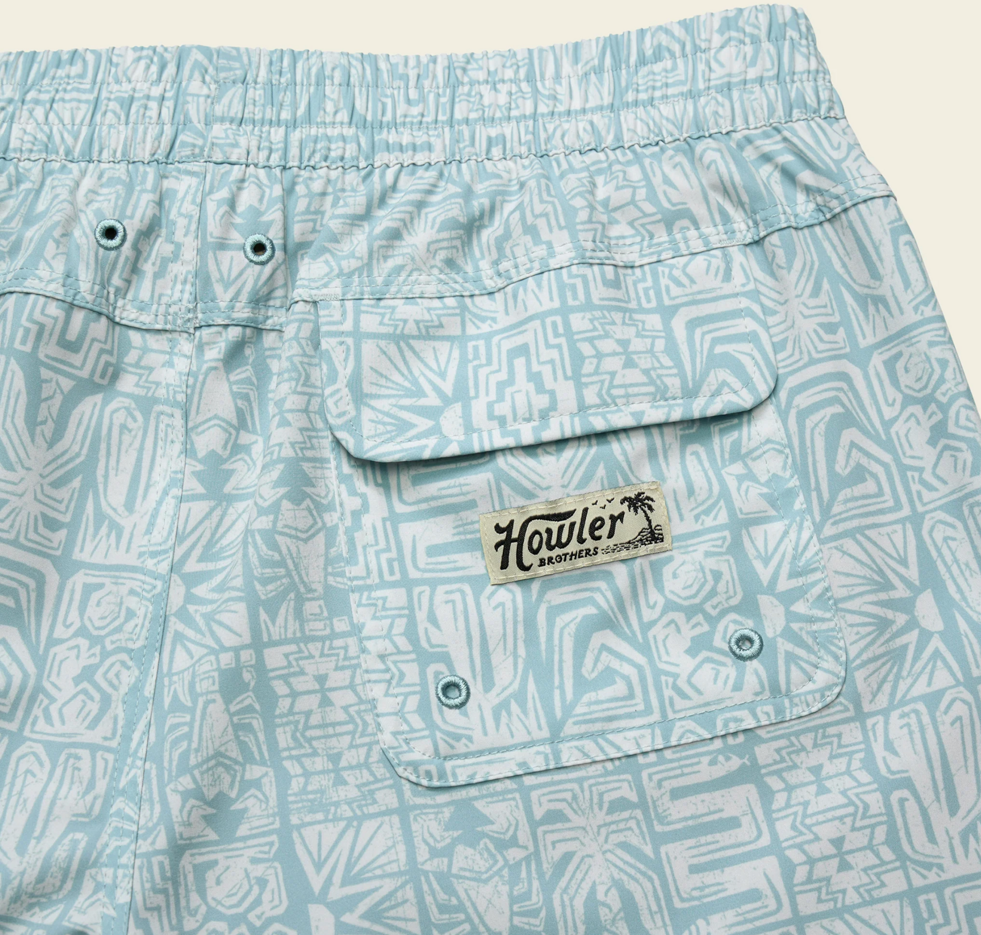 Light blue shorts with geometric pattern and Howler Brothers label on a beige background